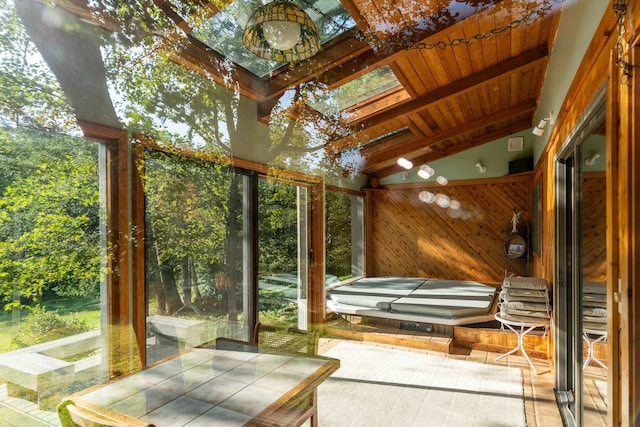 unfurnished sunroom with vaulted ceiling with beams and wooden ceiling