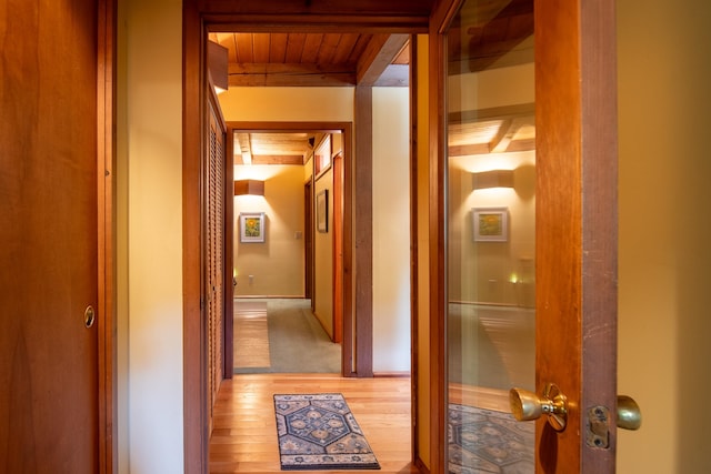 hallway with hardwood / wood-style floors and wooden ceiling