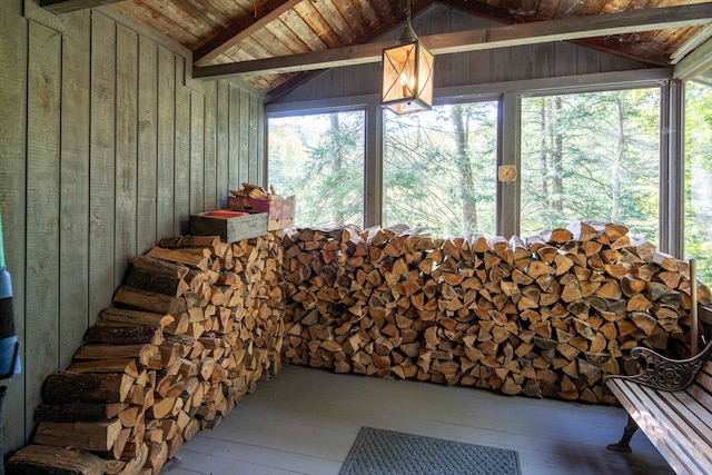 sunroom featuring wood ceiling and vaulted ceiling with beams