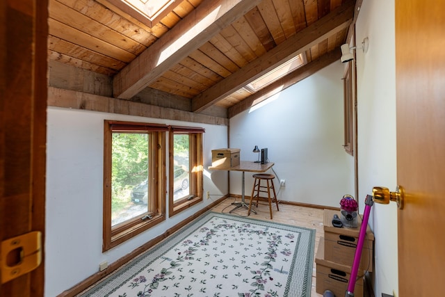 additional living space featuring wooden ceiling, vaulted ceiling with skylight, and hardwood / wood-style flooring