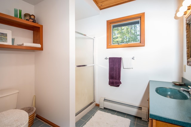 bathroom featuring vanity, an enclosed shower, toilet, a baseboard heating unit, and tile patterned floors