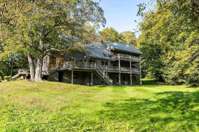 back of house with a yard and a deck