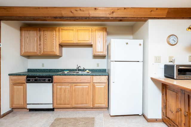 kitchen featuring white appliances, sink, and light tile patterned floors