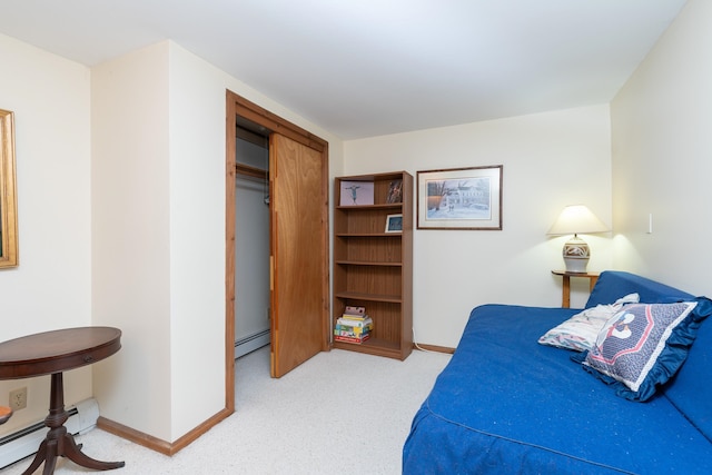 bedroom featuring a closet and baseboard heating