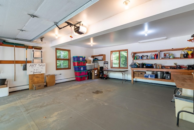 garage with a garage door opener and a baseboard heating unit