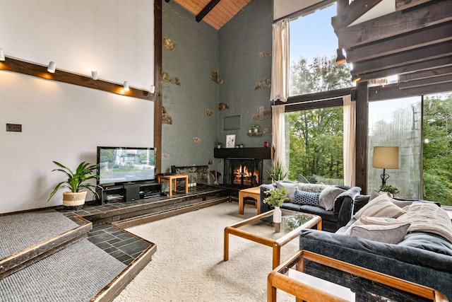 living room featuring wood ceiling, carpet flooring, high vaulted ceiling, and a wealth of natural light