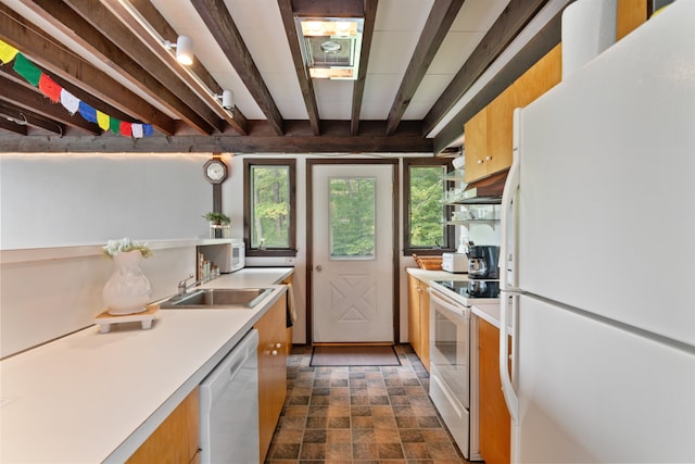 kitchen with beamed ceiling, sink, and white appliances