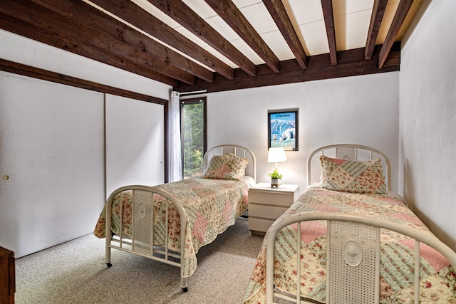 carpeted bedroom featuring beam ceiling