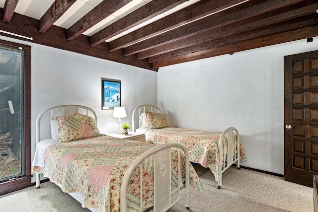 bedroom with beamed ceiling and light colored carpet