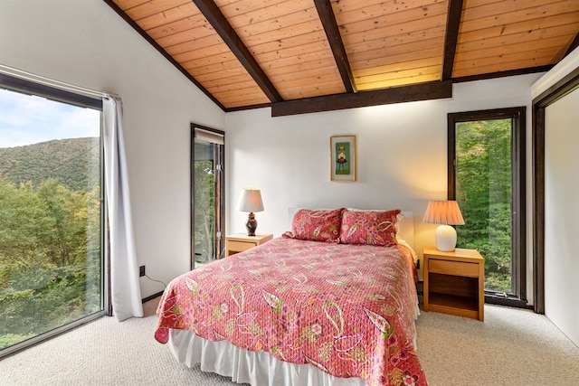 bedroom with lofted ceiling with beams, wood ceiling, carpet floors, and access to outside