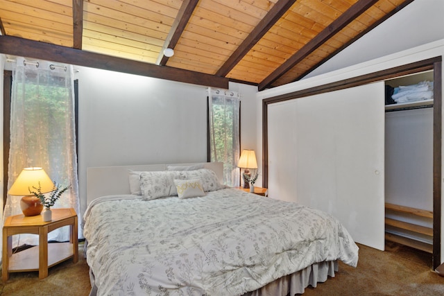 carpeted bedroom with vaulted ceiling with beams, wood ceiling, and a closet