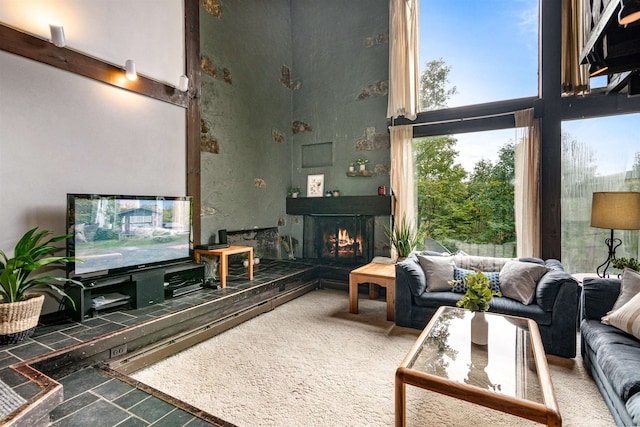 carpeted living room with a towering ceiling