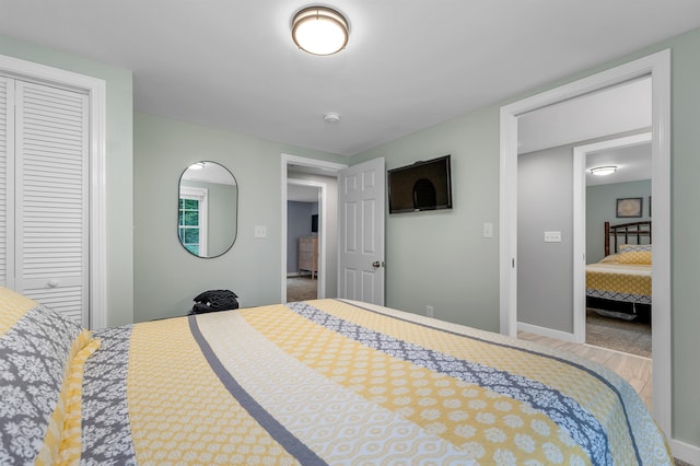 bedroom featuring hardwood / wood-style floors and a closet