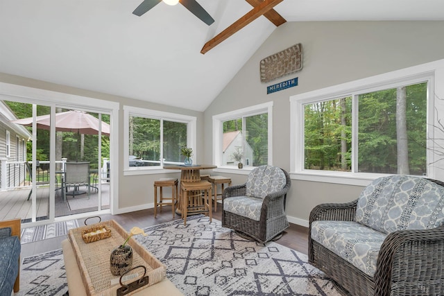 sunroom / solarium with ceiling fan, lofted ceiling, and a wealth of natural light