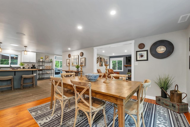 dining space with sink and light hardwood / wood-style flooring