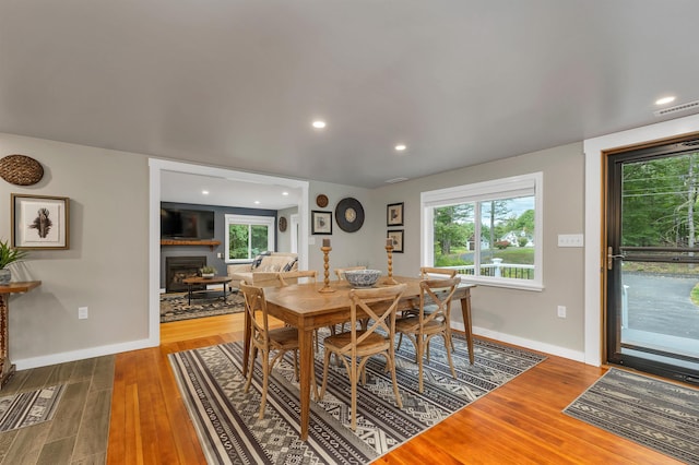 dining area with a healthy amount of sunlight and hardwood / wood-style floors