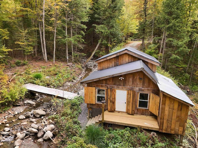 view of outdoor structure featuring a forest view