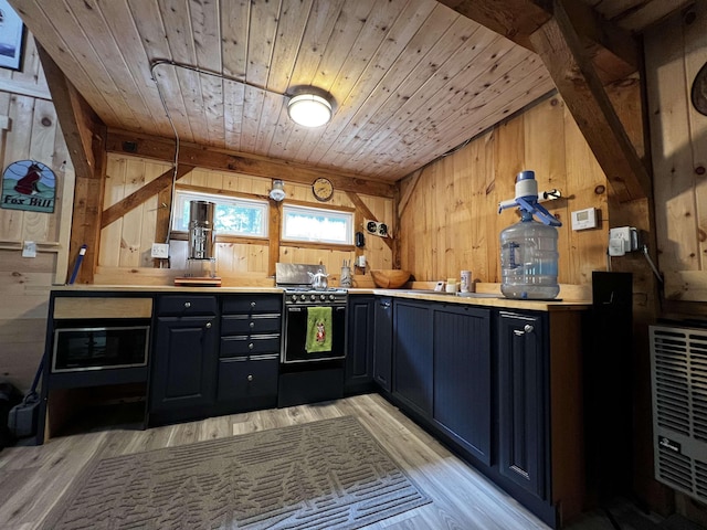 kitchen featuring wooden ceiling, light countertops, light wood-style flooring, and wooden walls