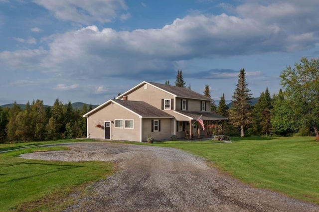 130 Center Rd, Hardwick, VT 05843 - view of front of house featuring covered porch, a front lawn, and curved driveway