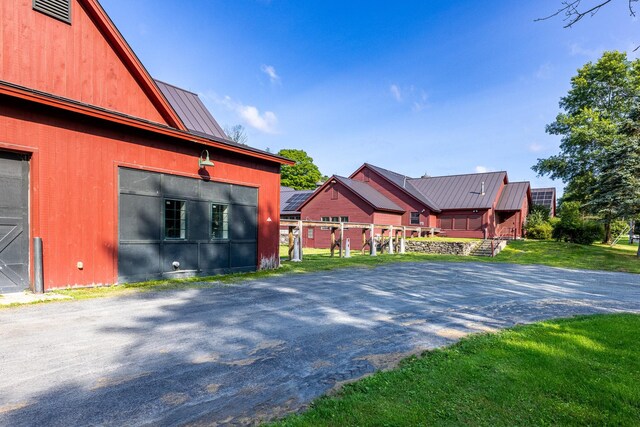 view of side of home with a yard