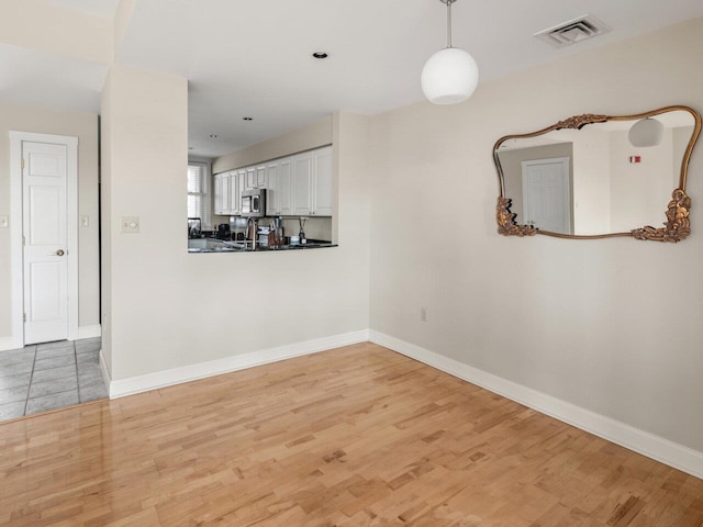 unfurnished dining area with wood-type flooring