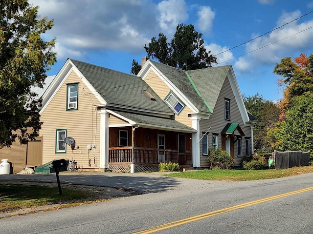 view of front facade with a porch and a chimney