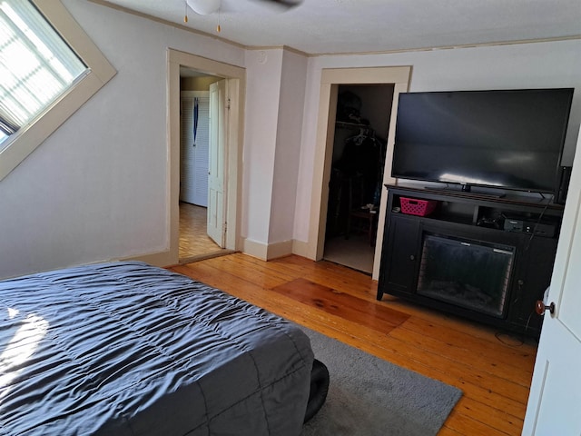 bedroom featuring light wood finished floors and ornamental molding