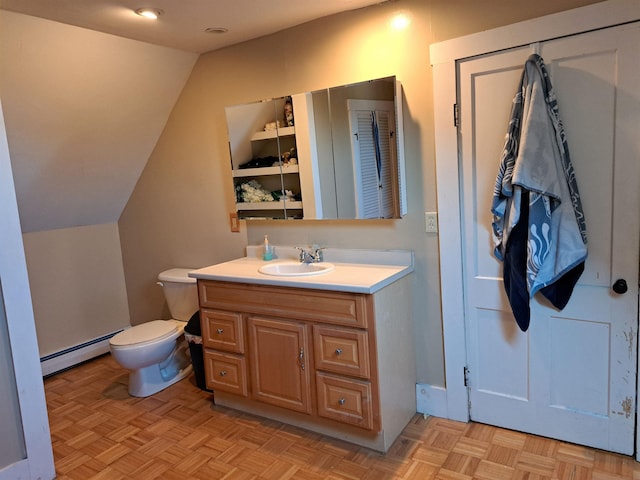 bathroom featuring baseboard heating, vanity, lofted ceiling, and toilet