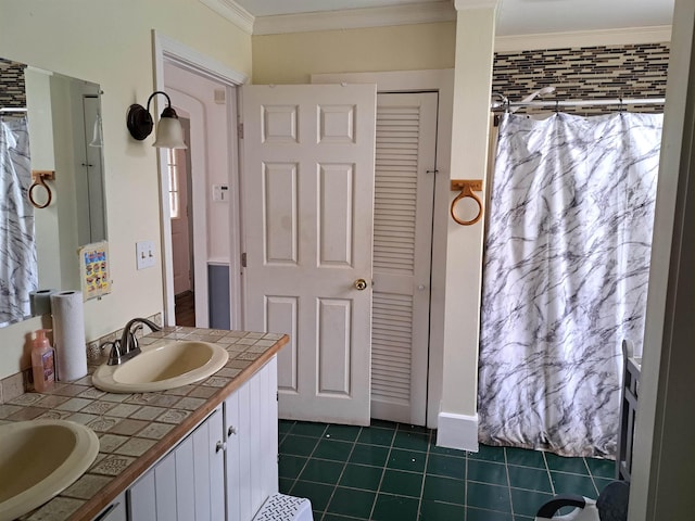 full bath with tile patterned floors, double vanity, a sink, and ornamental molding