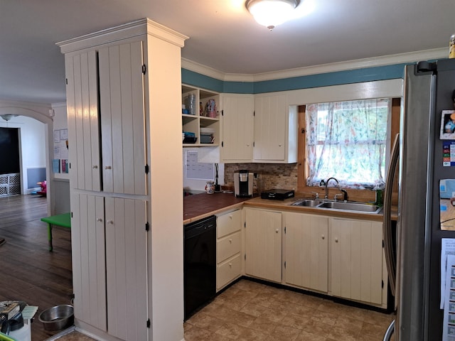 kitchen with freestanding refrigerator, tasteful backsplash, ornamental molding, black dishwasher, and a sink