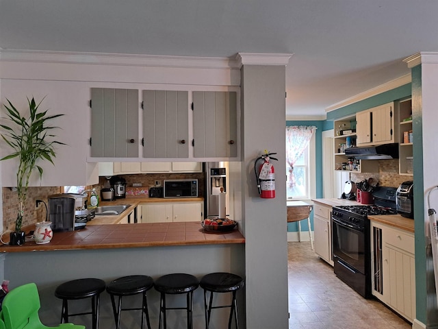 kitchen featuring range hood, open shelves, ornamental molding, black appliances, and decorative backsplash