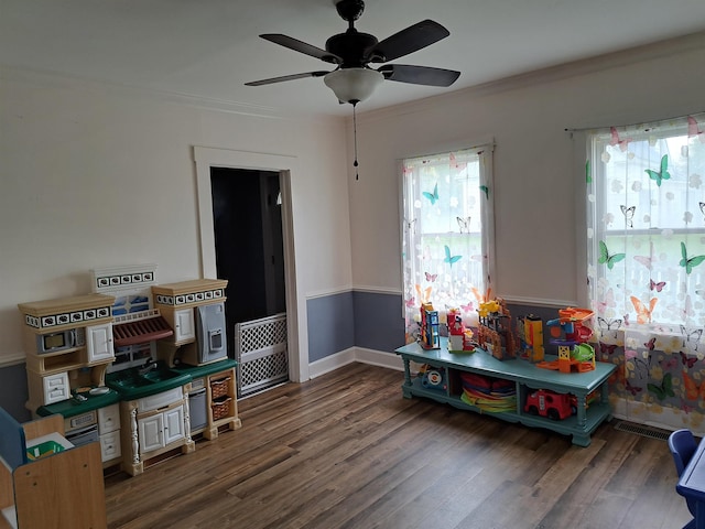 game room with wood finished floors, baseboards, a ceiling fan, and visible vents
