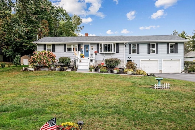 view of front facade with a shed, a garage, and a front yard