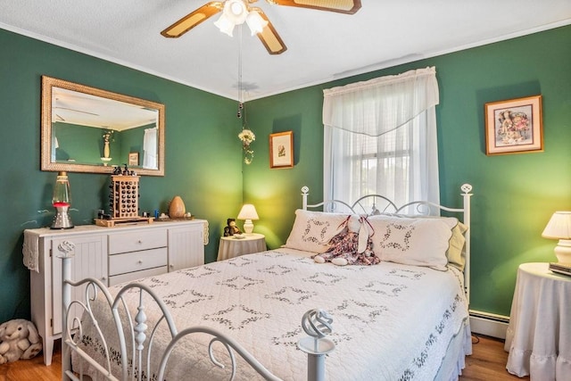 bedroom featuring light wood-type flooring, baseboard heating, and ceiling fan