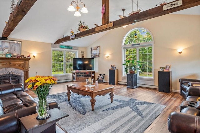 living room with light wood-type flooring, a healthy amount of sunlight, and baseboard heating