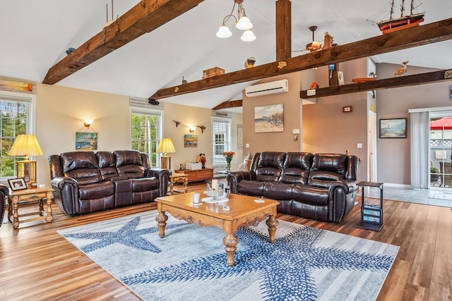 living room featuring high vaulted ceiling, an AC wall unit, beamed ceiling, light wood-type flooring, and a chandelier