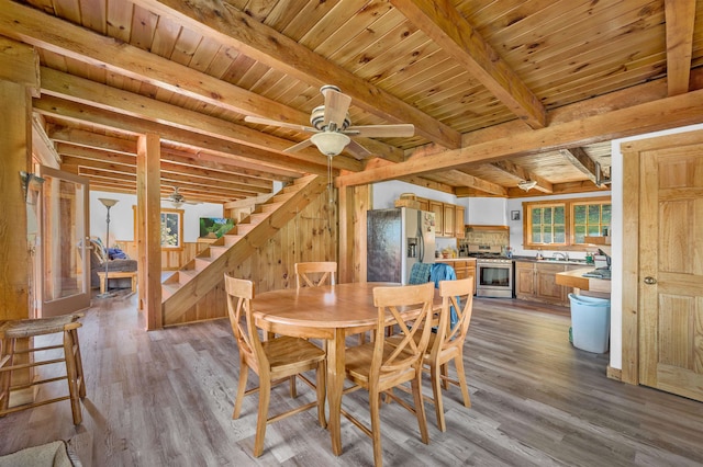 dining room featuring wood ceiling, light wood-type flooring, and ceiling fan