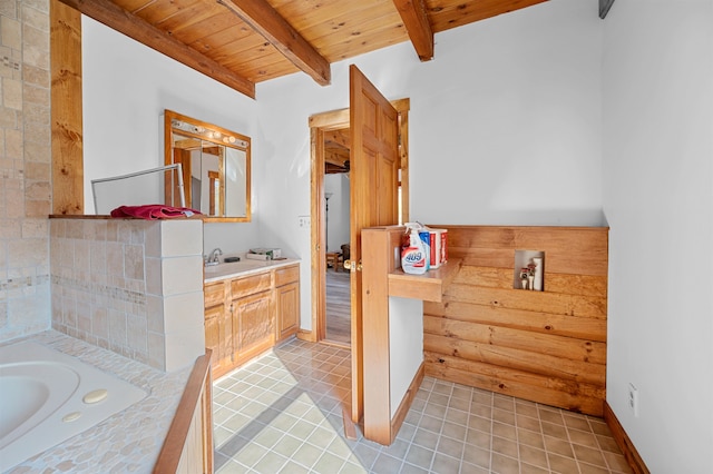 bathroom with wood ceiling, vanity, beam ceiling, a washtub, and tile patterned floors