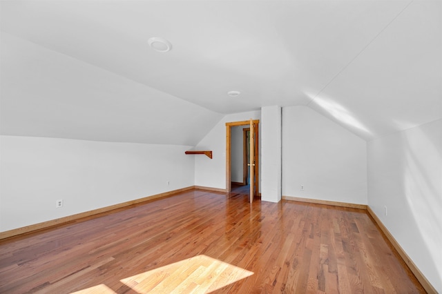 bonus room with wood-type flooring and lofted ceiling