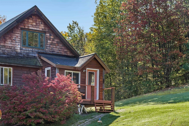 rear view of house featuring a yard