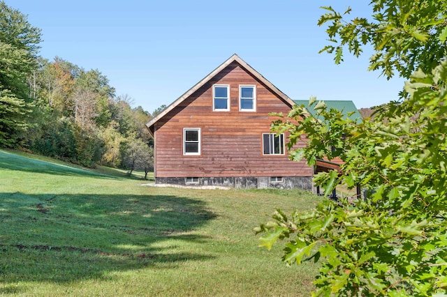 view of property exterior with a lawn