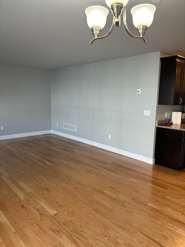 interior space with a notable chandelier and light hardwood / wood-style floors