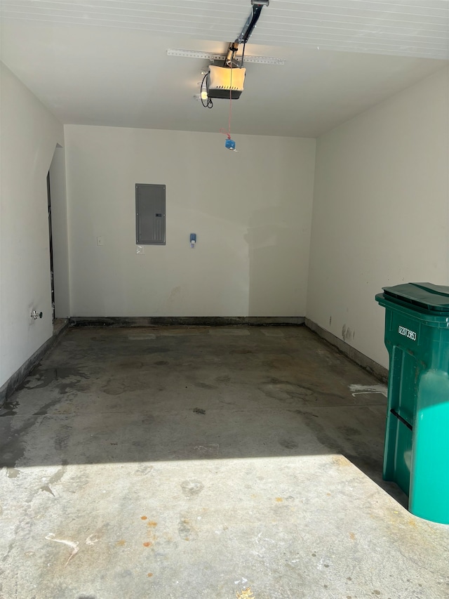 garage featuring electric panel and a garage door opener