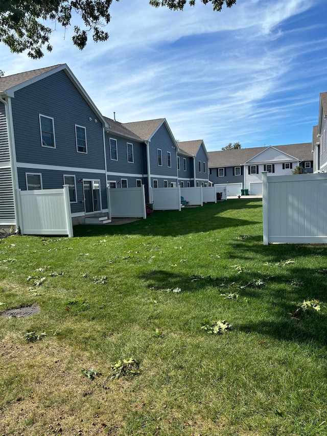 back of house with a lawn