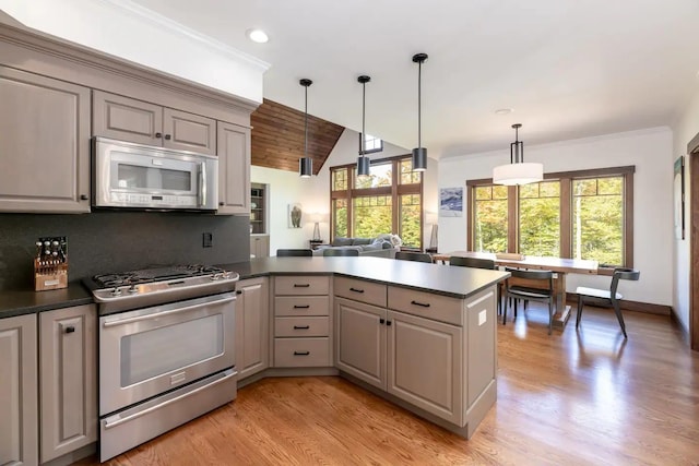 16 Crooked Mountain Rd, Lincoln, NH 03251 - kitchen featuring gas range, a peninsula, dark countertops, gray cabinets, and lofted ceiling