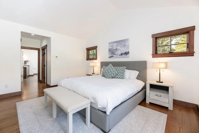 16 Crooked Mountain Rd, Lincoln, NH 03251 - bedroom with wood finished floors, multiple windows, and vaulted ceiling