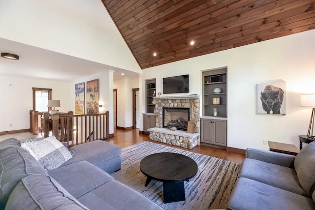 16 Crooked Mountain Rd, Lincoln, NH 03251 - living area featuring a stone fireplace, built in shelves, dark wood-style flooring, and high vaulted ceiling