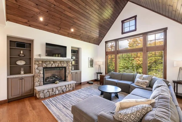 16 Crooked Mountain Rd, Lincoln, NH 03251 - living room with high vaulted ceiling, a stone fireplace, wood finished floors, wood ceiling, and built in shelves