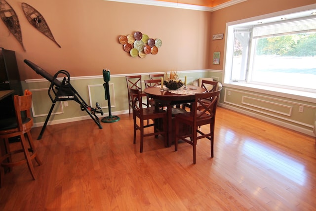 dining room featuring ornamental molding and light hardwood / wood-style flooring