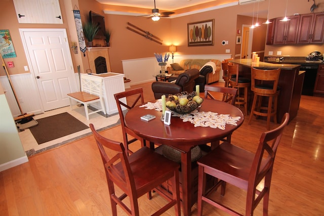 dining space with light hardwood / wood-style flooring, ceiling fan, and crown molding